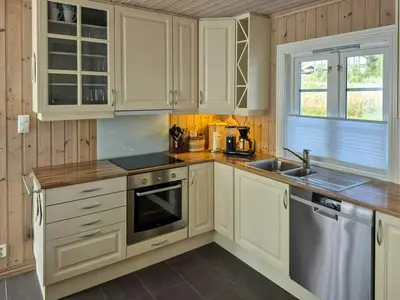 a kitchen with white cabinets and a sink at Mountain Gem With Ski In And Out At Golsfjellet in Gol