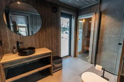a bathroom with a sink and a mirror at Luxury holiday home, skiing, sauna, remote office in Nesbyen