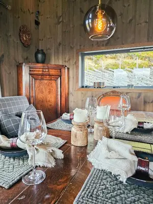 a wooden table with wine glasses on top of it at Mountain Cabin With Panoramic Views In Oppdal in Oppdal