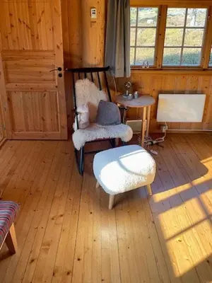 a room with a table and chairs and a table and a door at Family Cabin At Birkebeiner Slopes In Sjusjøen in Sjusjøen
