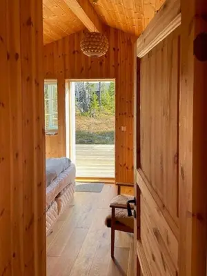 a hallway of a wooden cabin with a sliding glass door at Family Cabin At Birkebeiner Slopes In Sjusjøen in Sjusjøen