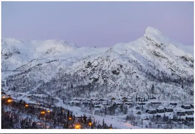 a snow covered mountain with a town and a ski resort at Family house in Hemsedal in Hemsedal