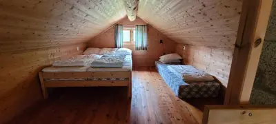 a room with two beds in a log cabin at Hytte ved Gaularfjellet in Viksdalen