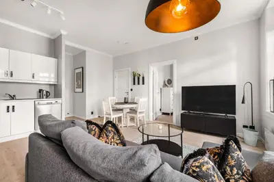 a living room with a couch and a table at Bergen Beds Apartments - A Front Row Experience in Bergen