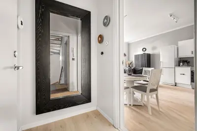 a mirror on a wall in a room with a table at Bergen Beds Apartments - A Front Row Experience in Bergen