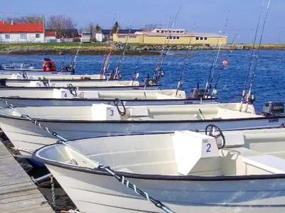 a group of boats tied to a dock in the water at Seaside Retreat with Boats & Fishing in Brekstad