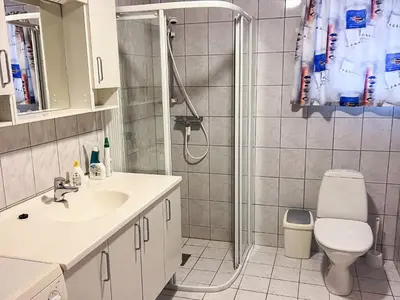 a bathroom with a shower and a toilet and a sink at Seaside Retreat with Boats & Fishing in Brekstad