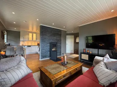 a living room with a red couch and a fireplace at Cozy apartment in Vestlia, Geilo in Geilo