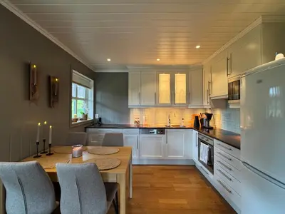 a kitchen with white cabinets and a table and chairs at Cozy apartment in Vestlia, Geilo in Geilo