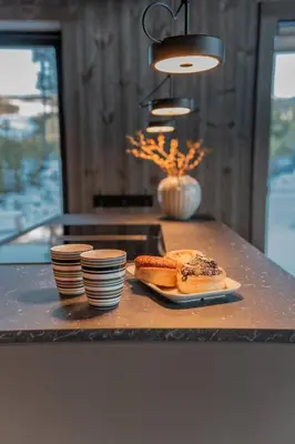 a counter with a table with a plate of food at Ski centre, sauna, hot tub