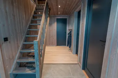 a staircase in a house with wooden walls at Tiur, stylish new cabin with hot tub in Nesbyen