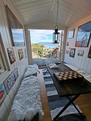 a room with a table and a couch in it at Villa with lake view in Lunde