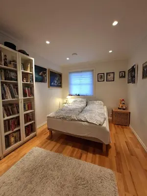 a bedroom with a bed and a window at Villa with lake view in Lunde