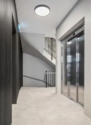a hallway with a staircase and a glass door at Bergen city centre, fantastic, new apartment in Bergen