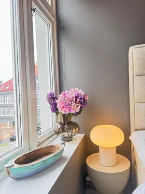 a bathroom with a sink and flowers in a window at Bergen city centre, fantastic, new apartment in Bergen