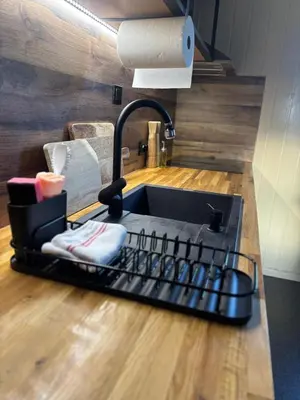 a kitchen sink sitting on top of a wooden floor at Martini Fishing Camp in Lauvsnes