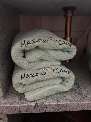 a pile of towels on a counter with writing on them at Martini Fishing Camp in Lauvsnes