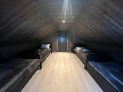 a room with two beds and a wooden ceiling at Robelia - Sauna, Hot tub - Norefjell ski center in Noresund