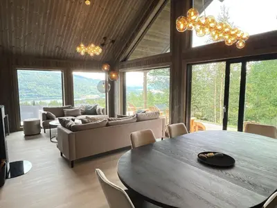 a living room with a table and a couch at Robelia - Sauna, Hot tub - Norefjell ski center in Noresund