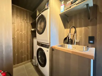 a small kitchen with a sink and a washing machine at Robelia - Sauna, Hot tub - Norefjell ski center in Noresund