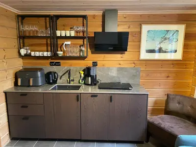 a kitchen with a counter and a sink in a room at Small cabin at Seljestad in Utsikten