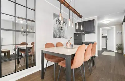 a kitchen and dining room with a table and chairs at Mountain apartment Norefjell Ski in ski out in Surteberg