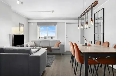 a living room and dining room with a couch and a table at Mountain apartment Norefjell Ski in ski out in Surteberg