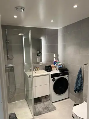 a bathroom with a washing machine and a shower at Modern apartment with view in Lii