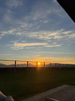 a sunset over a soccer field with a fence at Modern apartment with view in Lii
