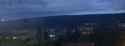 a view of a city and a river at night at Flora in Lillehammer