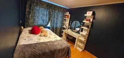 a bedroom with a bed with a teddy bear on it at Flora in Lillehammer