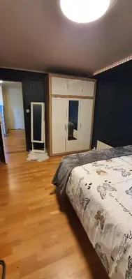 a bedroom with a bed and a wooden floor at Flora in Lillehammer