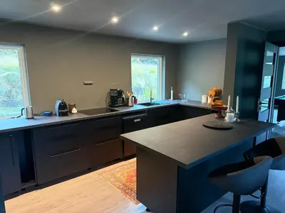 a kitchen with a large island in the middle at Fossen bratte chalet in Eikedalen