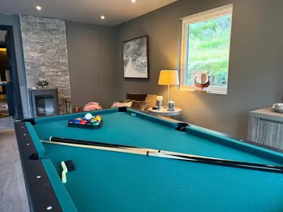 a pool table in a living room with a billiard room at Fossen bratte chalet in Eikedalen