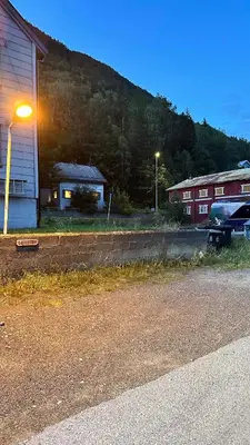 a street light next to a building and a car at Koselig 3 roms leilighet på Rjukan in Øverland