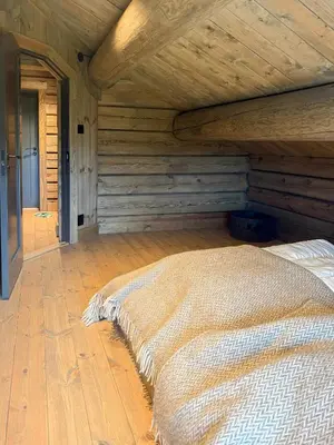 a bed in a room with a wooden ceiling at Modern Family Cabin Near Kikut In Geilo in Geilo