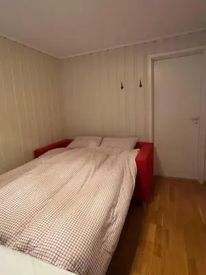 a small bedroom with a bed and a door at Beautiful apartment at Ustaoset in Hol