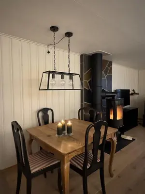 a dining room with a wooden table with candles on it at Beautiful apartment at Ustaoset in Hol