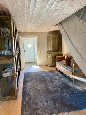 an attic room with a staircase and a couch at Bjarnebu - 4 bedroom cabin in Rauland in Rauland