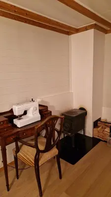 a sewing machine sitting on top of a wooden table at Apartment in peacefull surroundings in Ådnavik