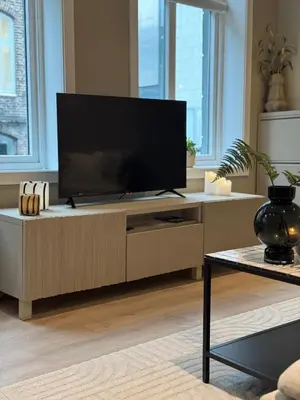 a living room with a flat screen tv on a cabinet at The best place to stay in city center - close to everything in Bergen