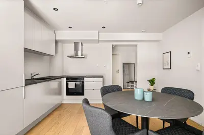 a kitchen and dining room with a table and chairs at Downtown Modern Apartment - Two Bedrooms! in Bergen