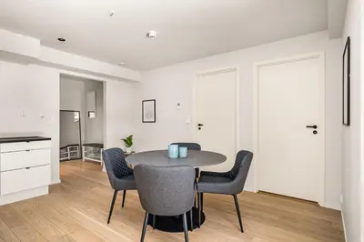 a kitchen and dining room with a table and chairs at Downtown Modern Apartment - Two Bedrooms! in Bergen
