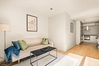 a living room with a couch and a table at Downtown Modern Apartment - Two Bedrooms! in Bergen