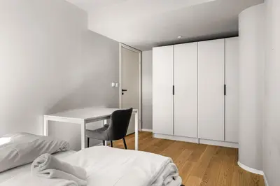 a bedroom with a desk and a bed and a chair at Downtown Modern Apartment - Two Bedrooms! in Bergen