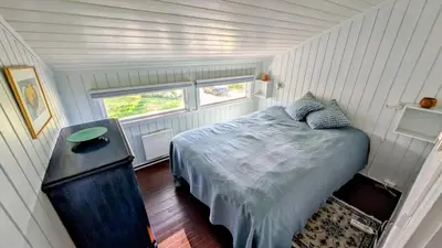 a small bedroom in a tiny house with a bed at Soltoppen - cozy 3 bedroom cabin close to Norefjell