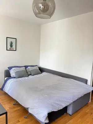 a bedroom with a large bed in a white room at Stay in the middle of Bergen city centre! in Bergen