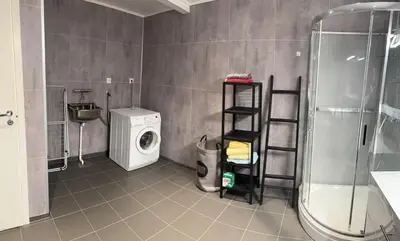 a bathroom with a washing machine and a washer at Large and bright apartment, perfect base in autumn in Ålesund
