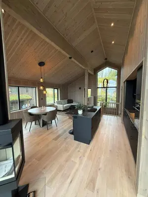a large living room with a table and a couch at Exclusive cabin with sauna and mountain view in Geilo in Hol