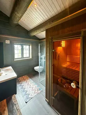 a bathroom with a shower and a toilet and a sink at Log Cabin With Views Of Jotunheimen in Øyer